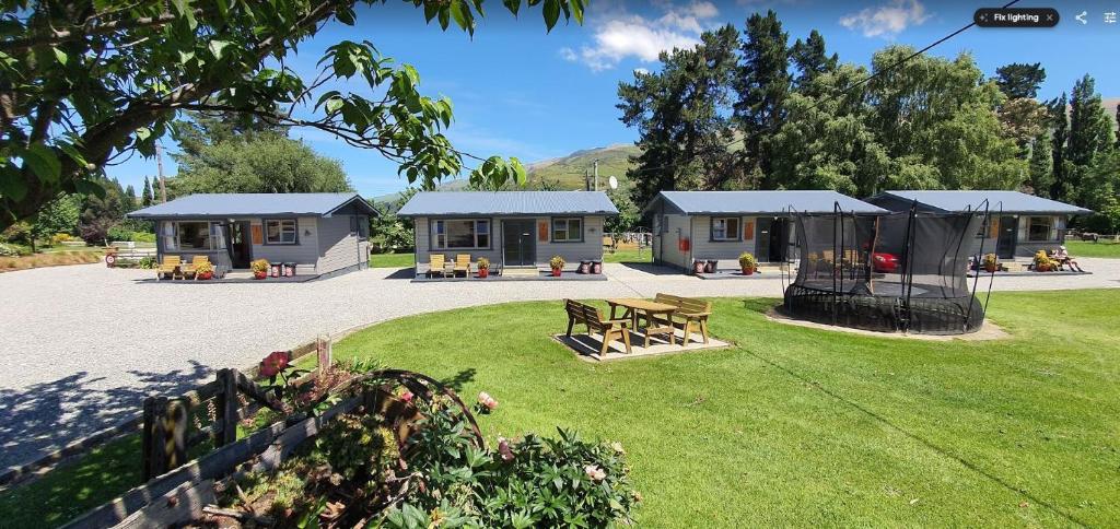 a group of houses in a park with a yard at Roxburgh Clutha Gold TOP 10 Holiday Park in Roxburgh
