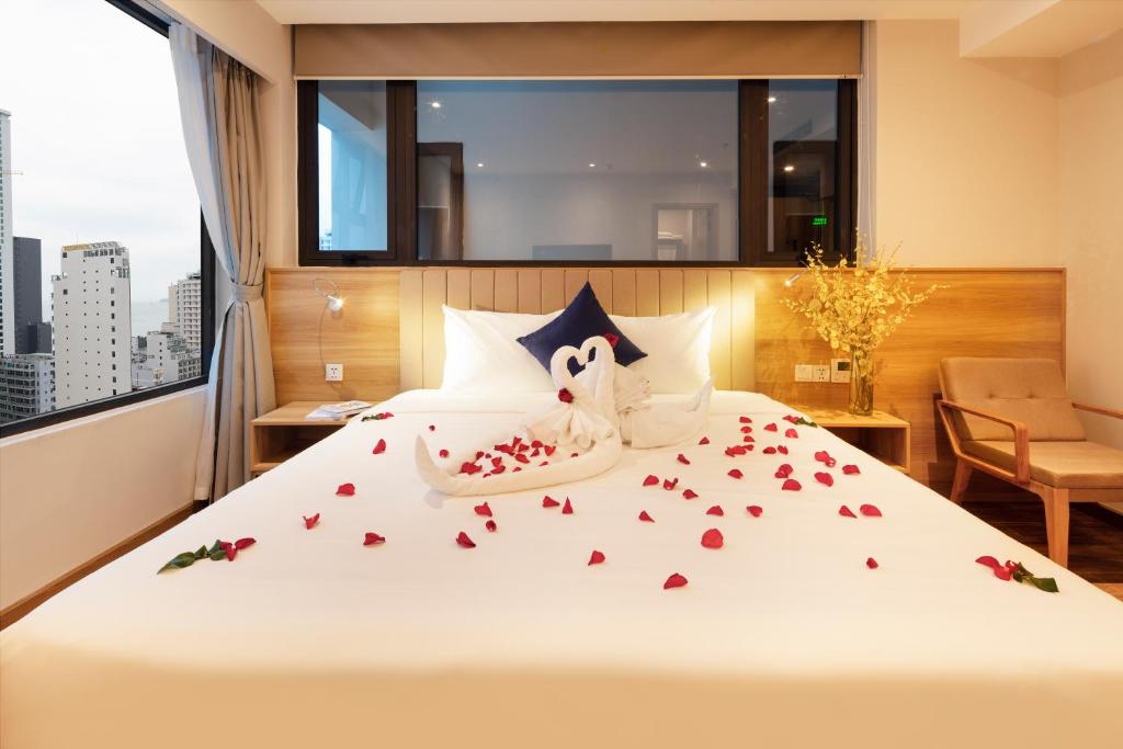 a hotel room with a bed with roses on it at VENTANA NHA TRANG HOTEL in Nha Trang