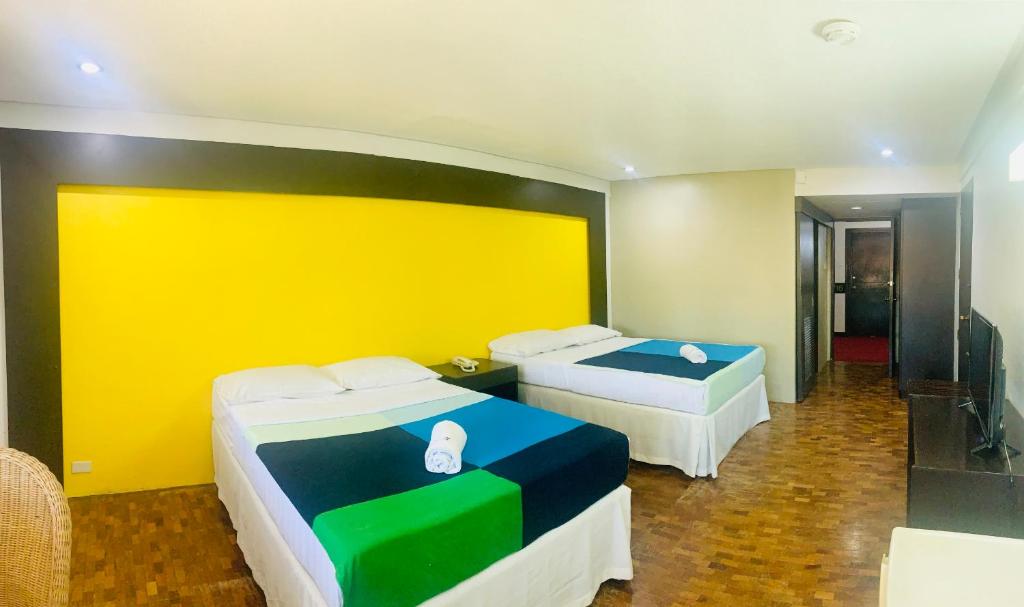 Postel nebo postele na pokoji v ubytování Maharajah Hotel