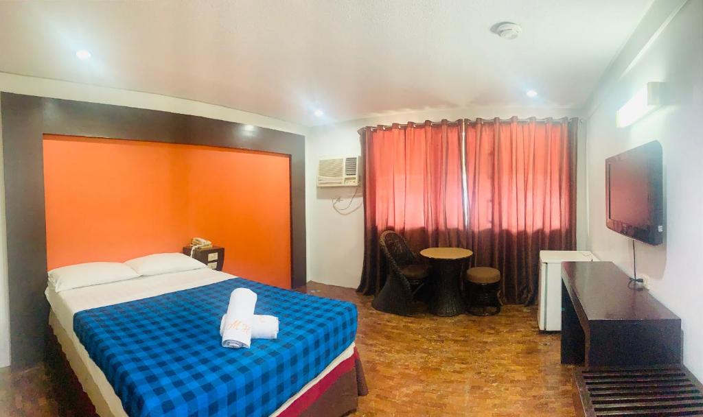 Postel nebo postele na pokoji v ubytování Maharajah Hotel