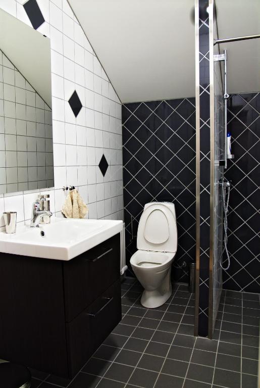 un bagno con un water, un lavandino e uno specchio di Pizza House Bed Simrishamn a Simrishamn