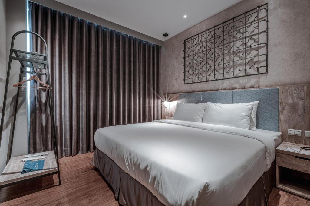 Postel nebo postele na pokoji v ubytování Somer Chew Hotel