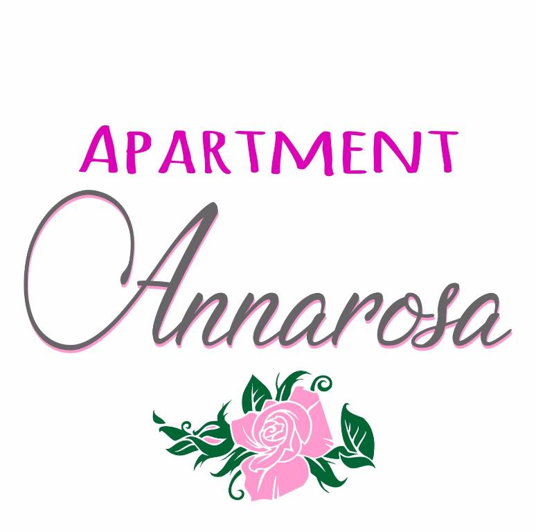 Um sinal para uma consulta na América com uma rosa rosa em Apartment Annarosa em Ronchi