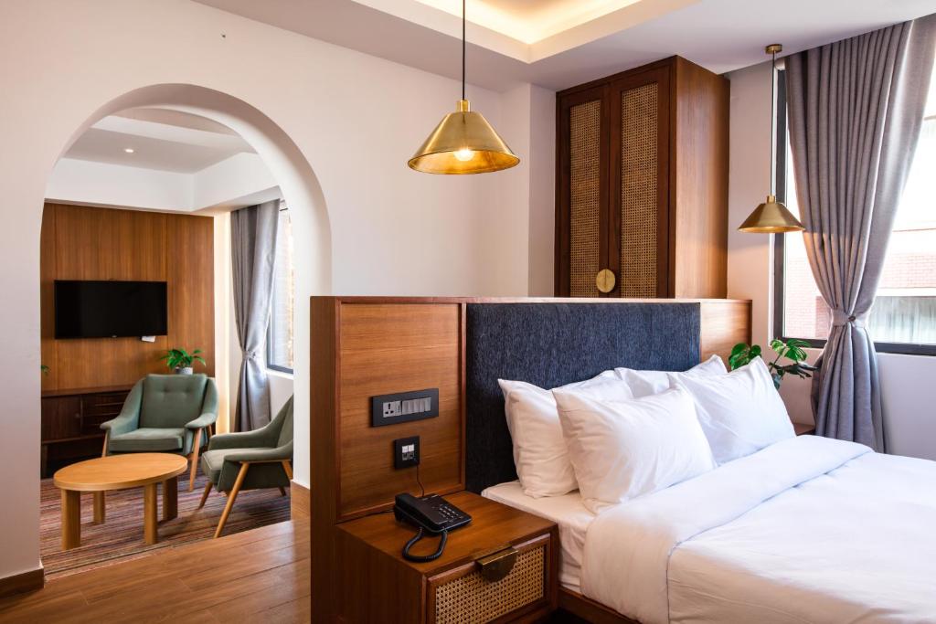 a hotel room with a bed and a desk at Nomad Hotel in Kathmandu