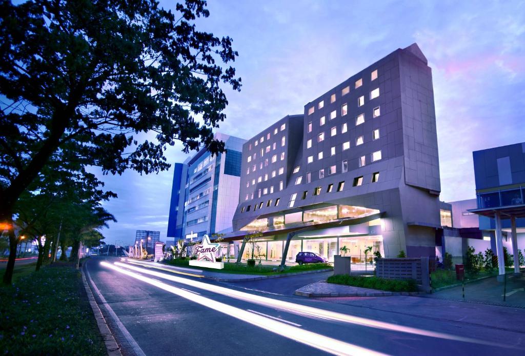 a building on a city street with buildings at Fame Hotel Gading Serpong in Serpong