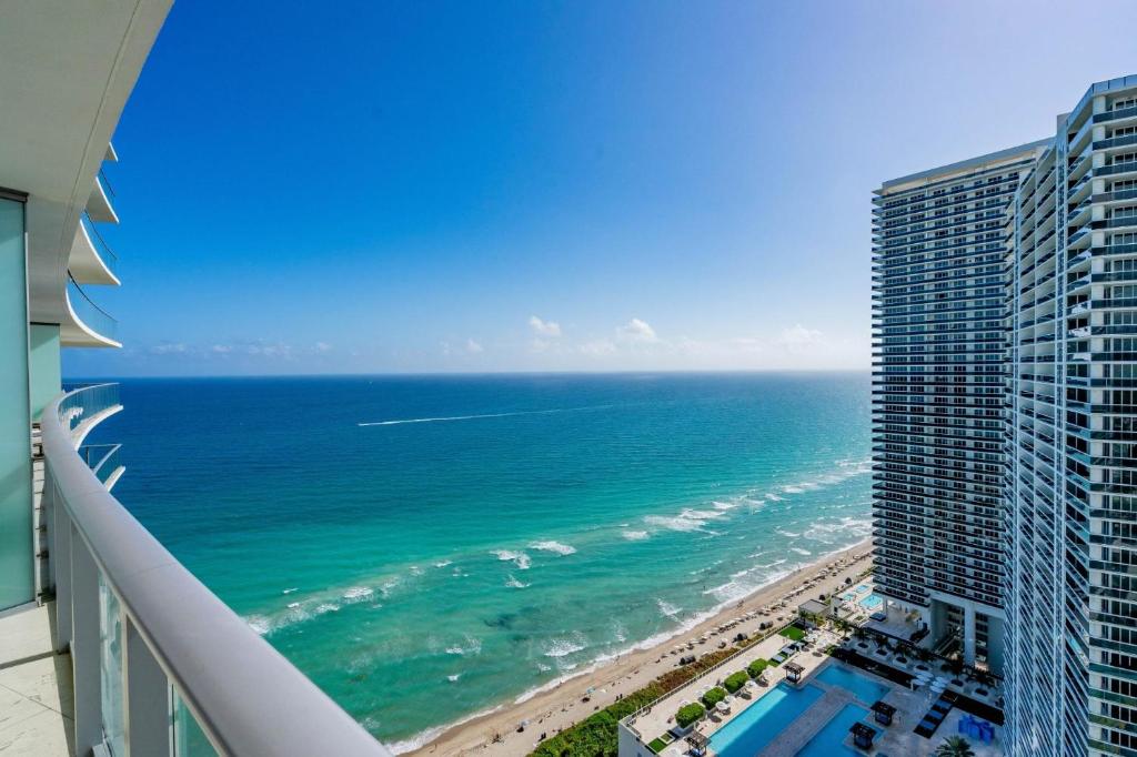 a view of the ocean from the balcony of a building at Ocean front 2 bedroom Hollywood Beach Resort 29th floor in Hallandale Beach