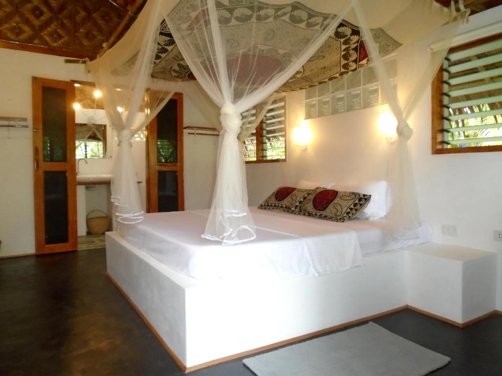 Postel nebo postele na pokoji v ubytování Nypa Style Resort Camiguin