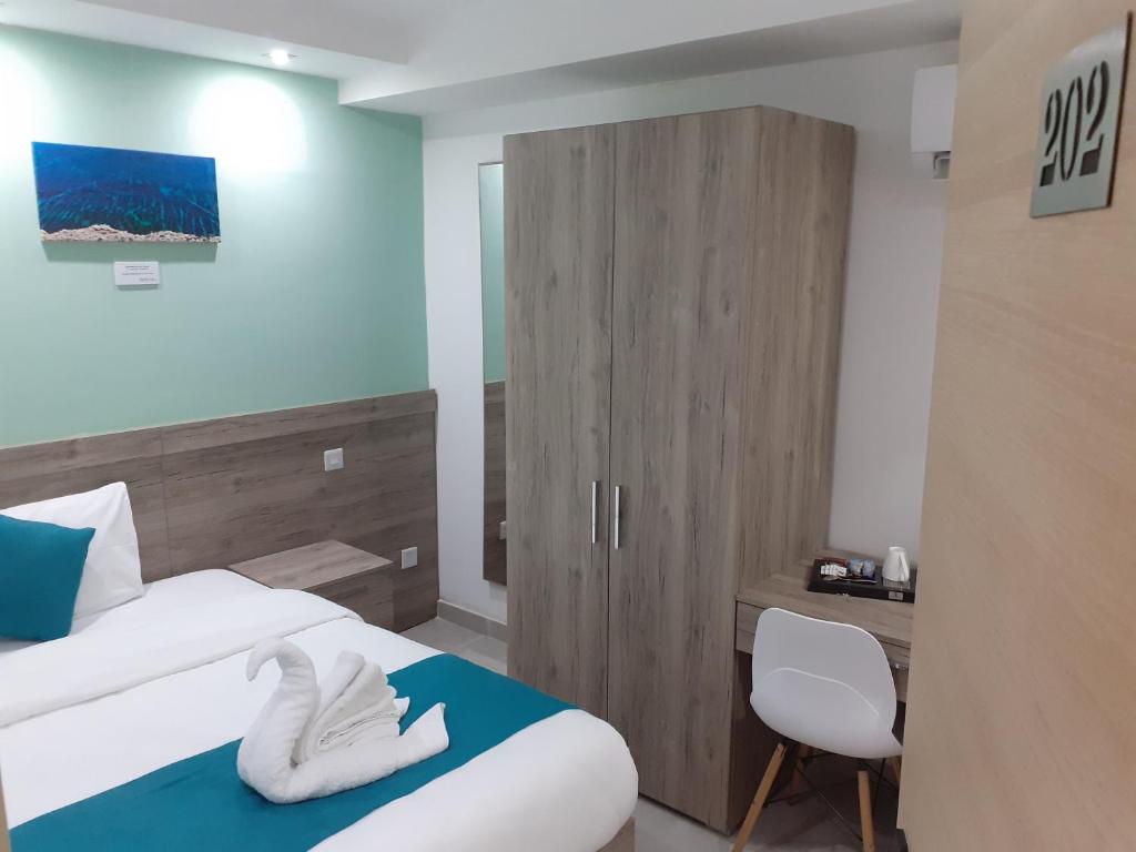 Postel nebo postele na pokoji v ubytování TJ Boutique