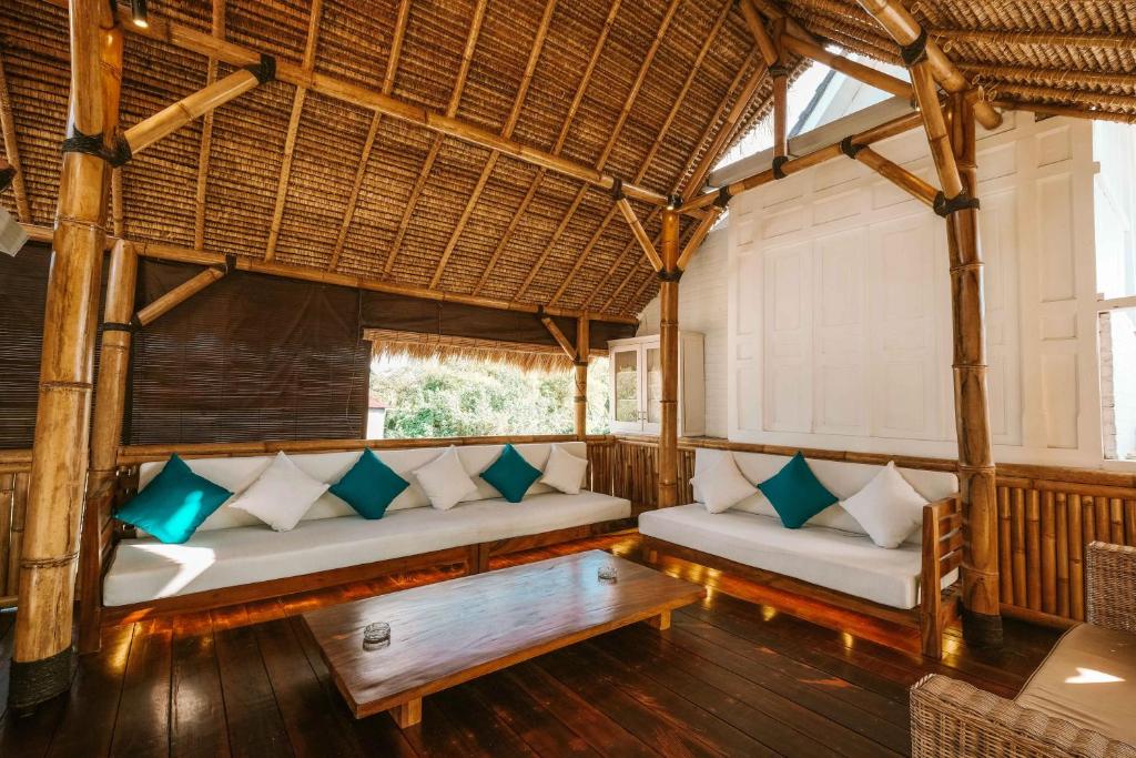 a living room with two couches and a table at The Palms Canggu in Canggu