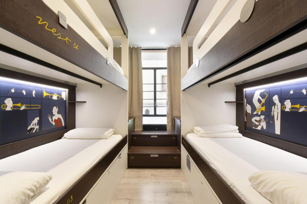 2 łóżka w pokoju wieloosobowym w hostelu w obiekcie Free Hostels Barcelona w Barcelonie