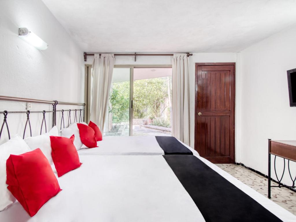 Postel nebo postele na pokoji v ubytování Hotel San Carlos