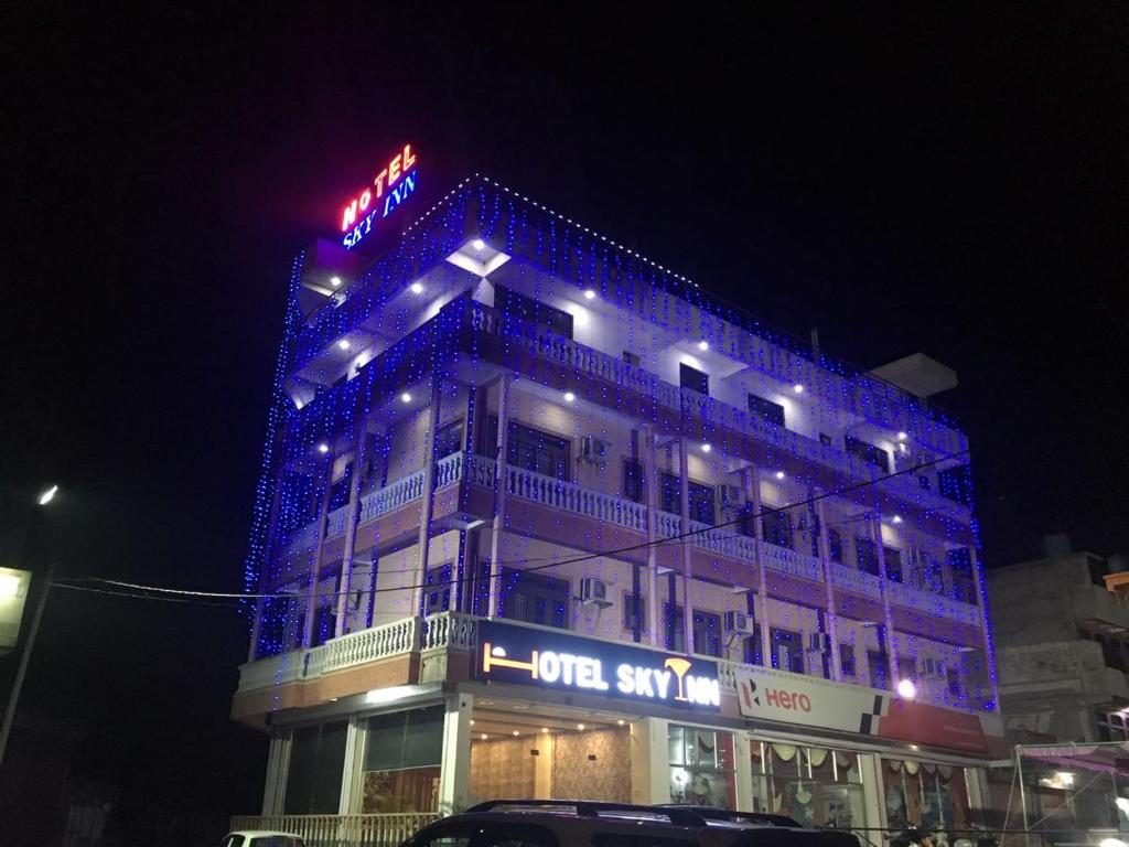 a building with blue lights on top of it at Hotel Sky Inn in Jaipur
