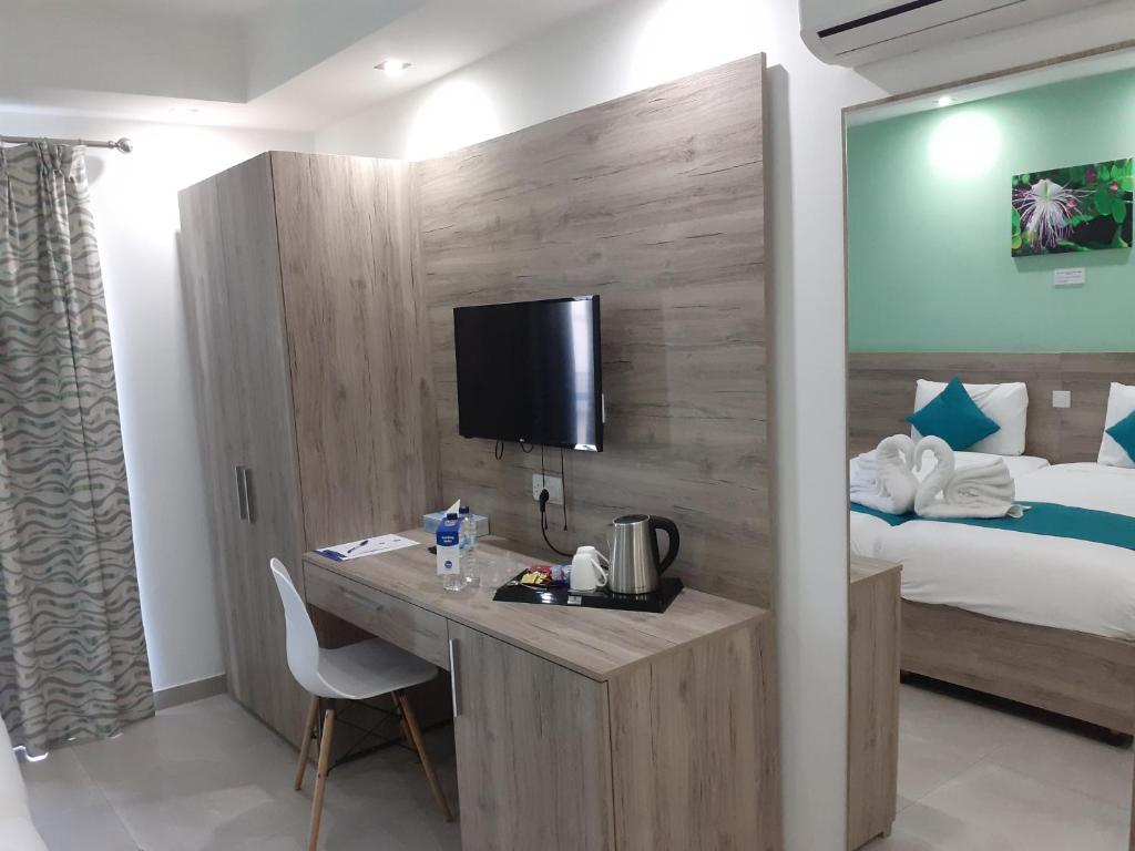 Postel nebo postele na pokoji v ubytování TJ Boutique