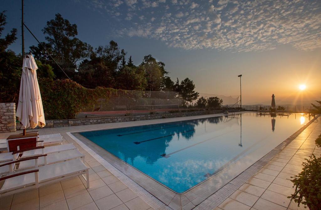 a large swimming pool with an umbrella and chairs at The Marmara Bodrum - Adult Only in Bodrum City