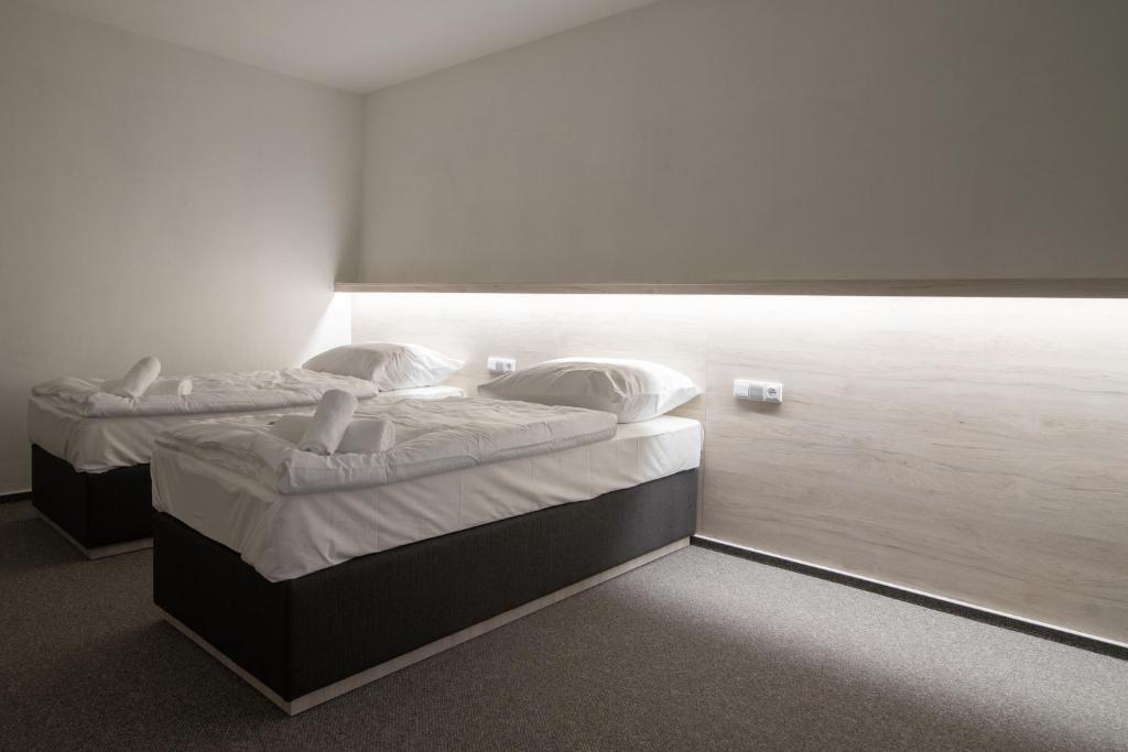 Postel nebo postele na pokoji v ubytování Garni hotel Roušarka