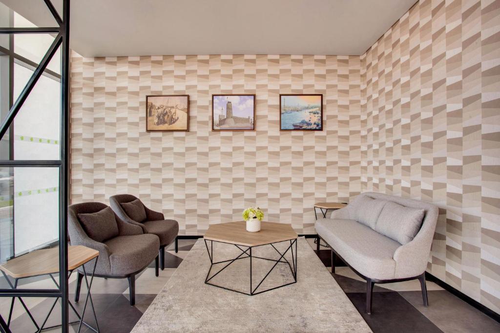 a waiting room with two chairs and a table at Lemon Tree Hotel, Jumeirah Dubai in Dubai