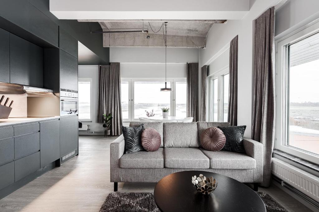 a living room with a couch and a table at Forenom Hotels & Apartments Arlanda in Arlanda