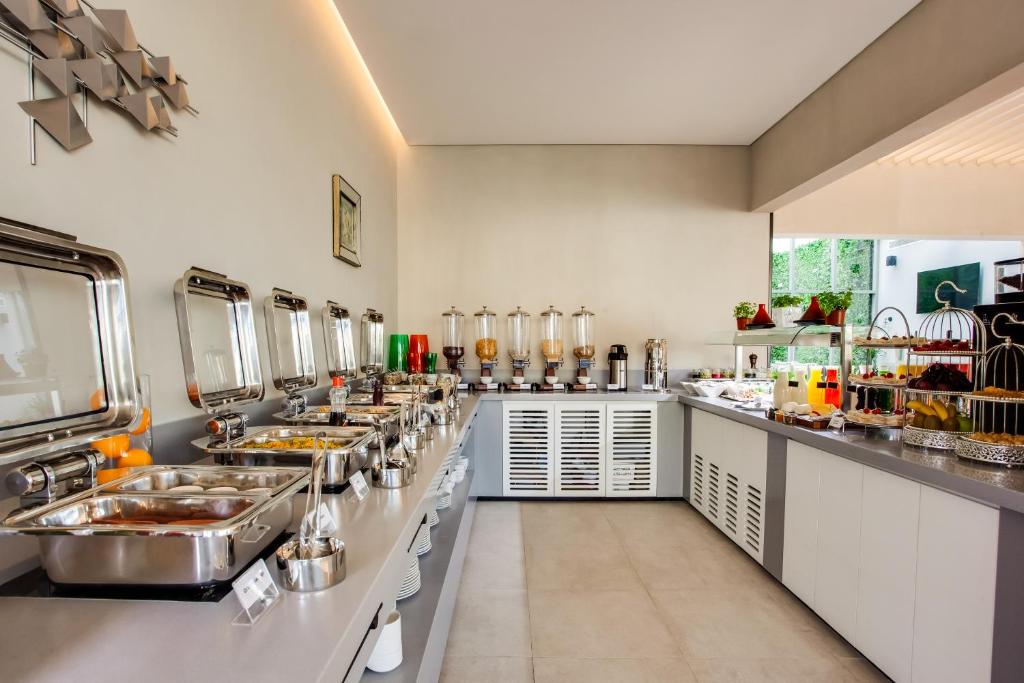 a large kitchen with many sinks and counters at Lemon Tree Hotel, Jumeirah Dubai in Dubai