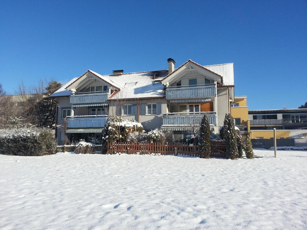 a house with a fence in the snow at Appartement Feldkirch in Feldkirch