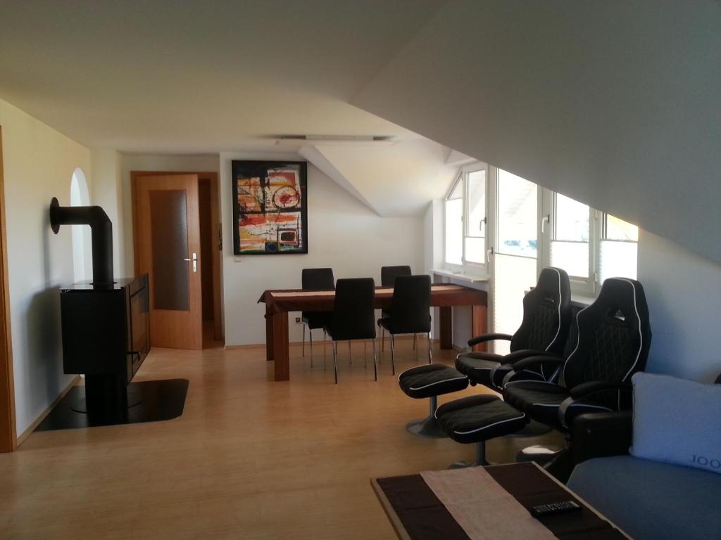 a living room with a dining room table and chairs at Appartement Feldkirch in Feldkirch