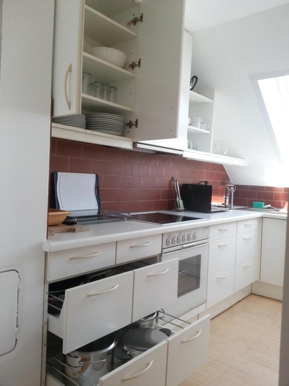 a kitchen with white cabinets and a sink at Appartement Feldkirch in Feldkirch