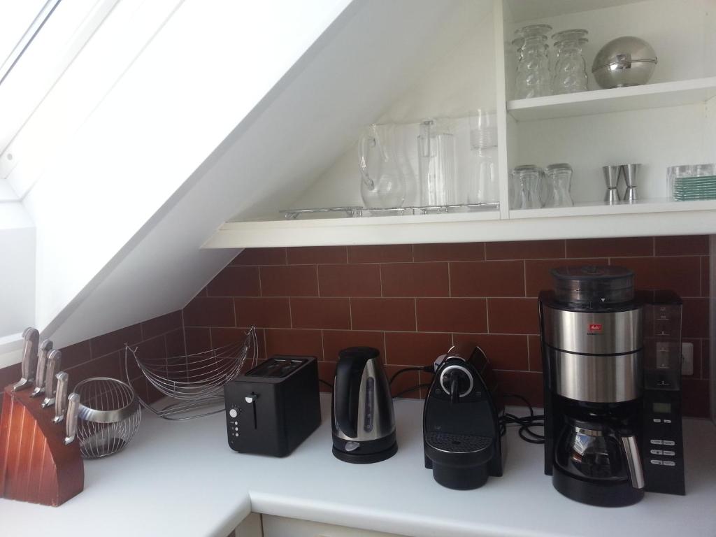 a kitchen counter with various appliances on a shelf at Appartement Feldkirch in Feldkirch