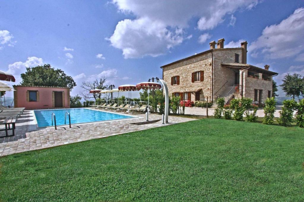 an external view of a villa with a swimming pool at Appartamento Corallo in Cagli