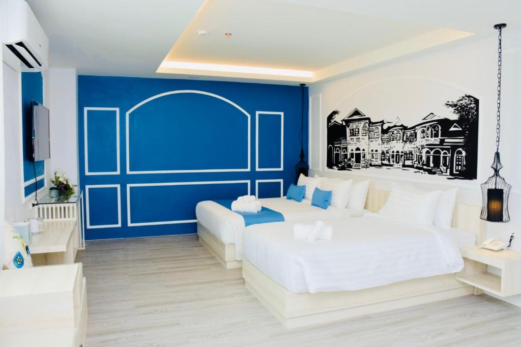 Postel nebo postele na pokoji v ubytování Peranakan House