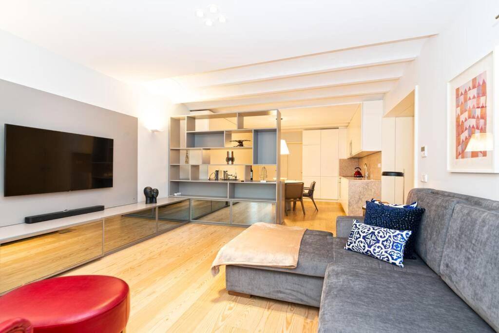 a living room with a couch and a large tv at Bairro Alto Premium Apartment in Lisbon