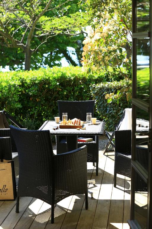 a table and chairs sitting on a patio at Le Pinarello in Sainte-Lucie de Porto-Vecchio
