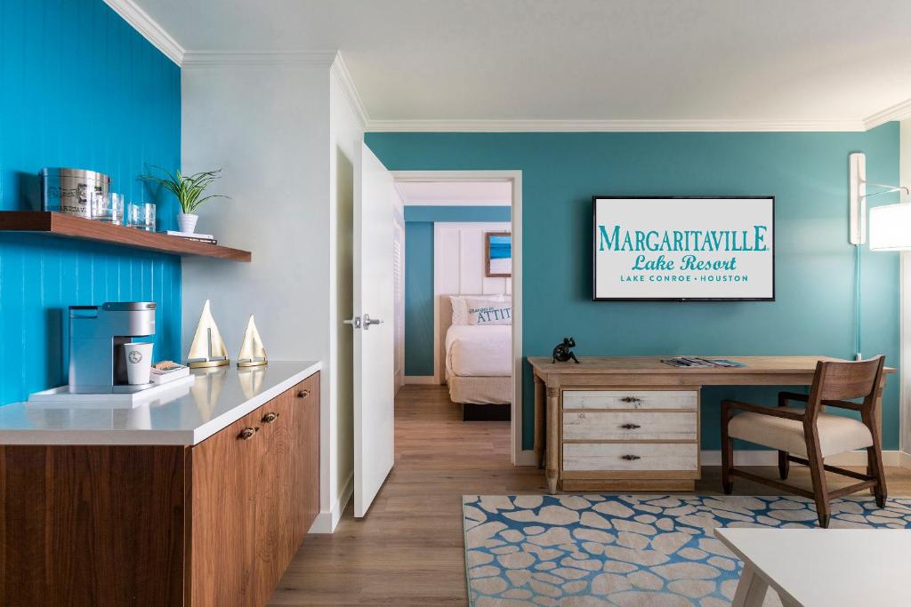 a room with a desk and a bedroom at Margaritaville Lake Resort, Lake Conroe in Montgomery