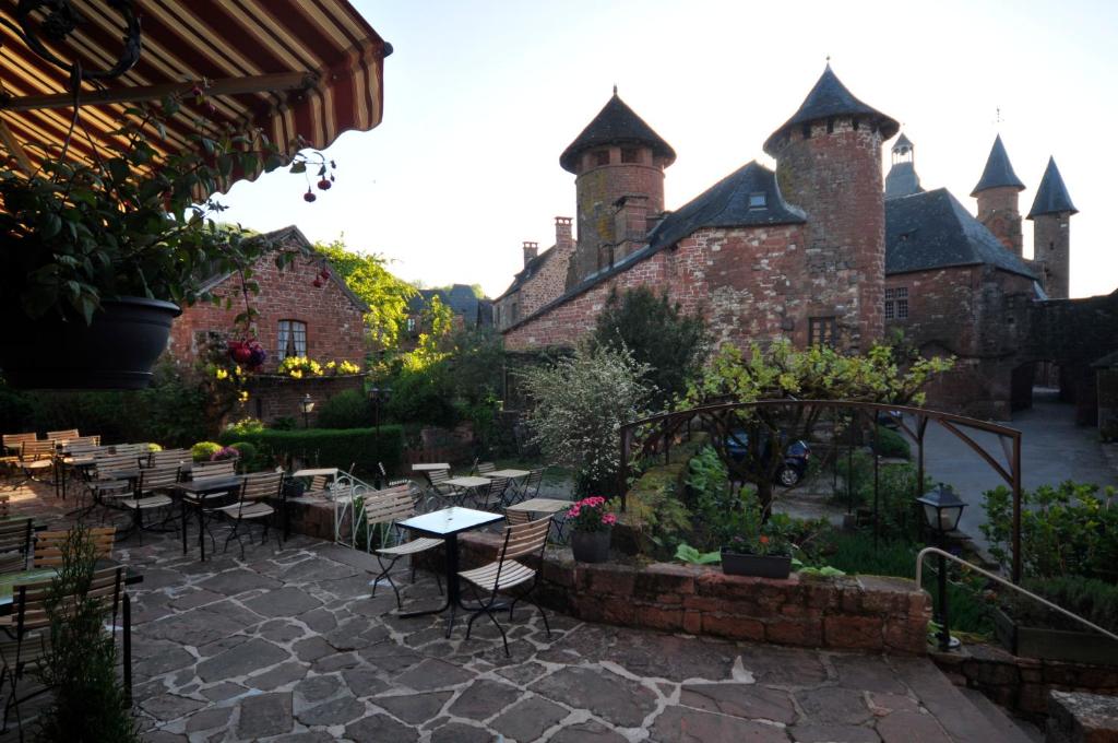a patio with tables and chairs in front of a building at Le Relais St jacques in Collonges
