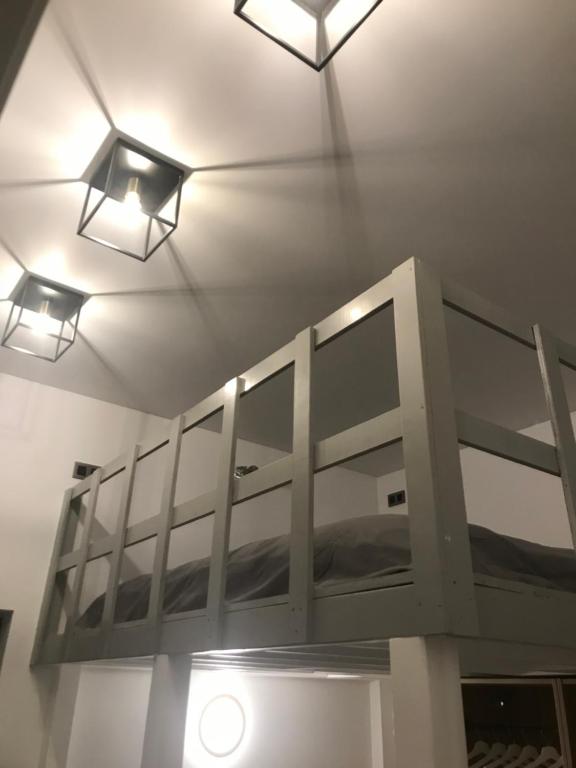 a room with two lights on the ceiling and a bunk bed at Antwerp West Side in Zwijndrecht