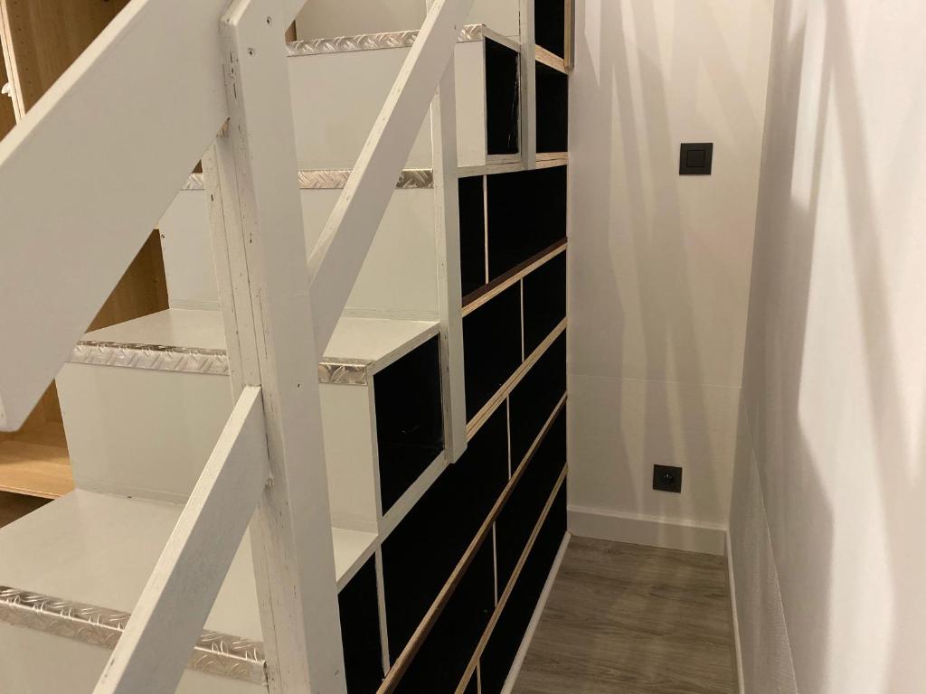 a stairwell with black and white shelves at Antwerp West Side in Zwijndrecht