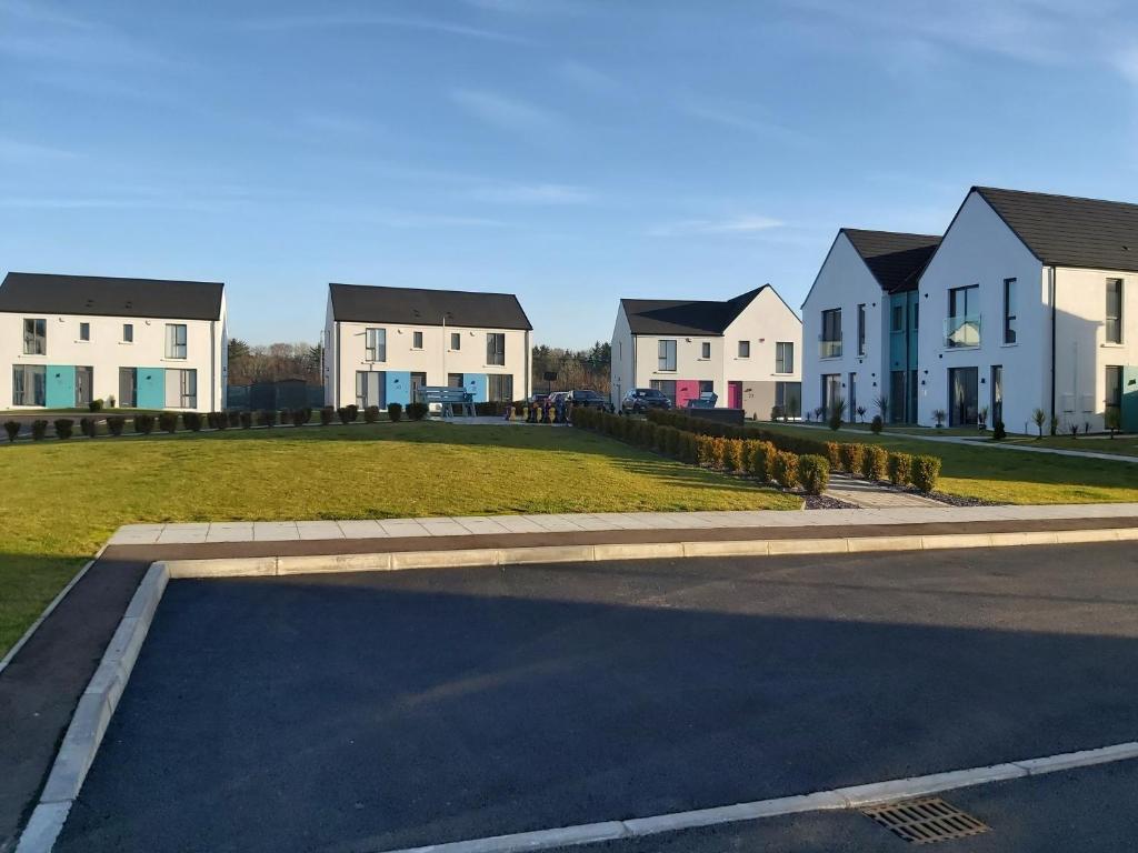 a row of houses on a street next to a road at Ayala in Portstewart