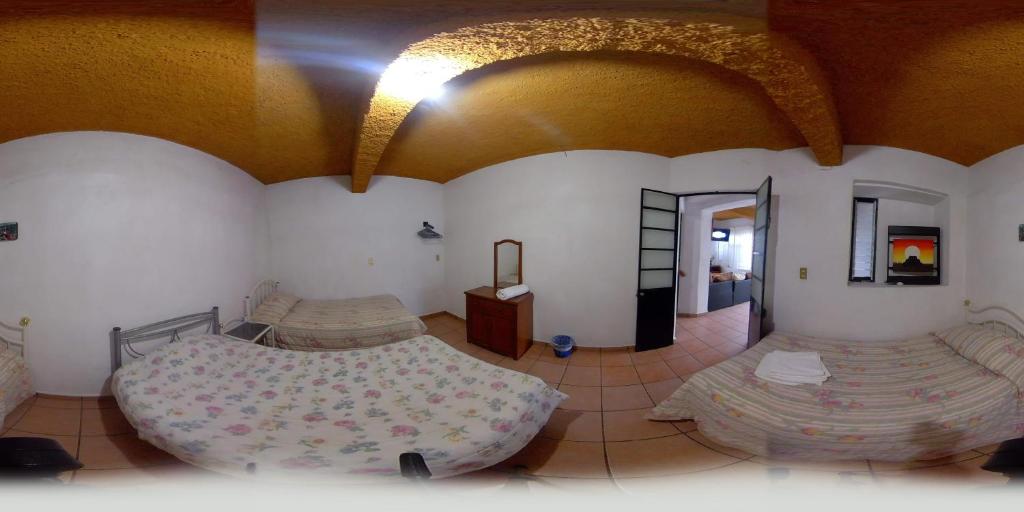 Postel nebo postele na pokoji v ubytování Posada Cuallicochi