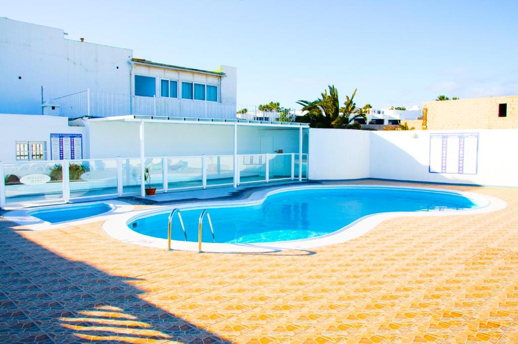 a swimming pool on the side of a house at Casa Tigot in Puerto del Carmen