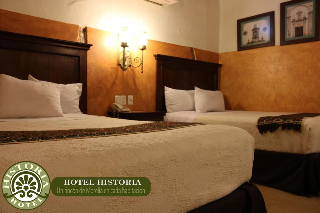 Postel nebo postele na pokoji v ubytování Hotel Historia