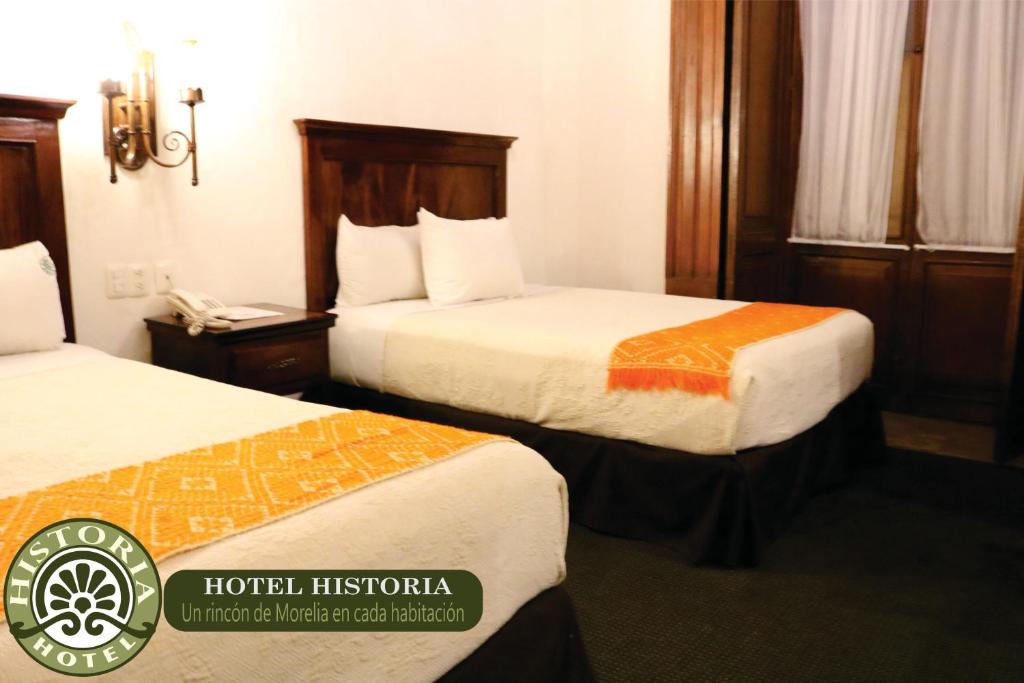 Postel nebo postele na pokoji v ubytování Hotel Historia