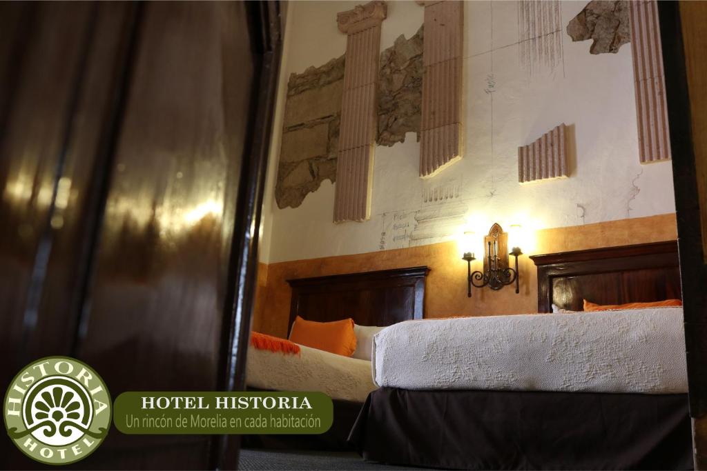 Postel nebo postele na pokoji v ubytování Hotel Historia