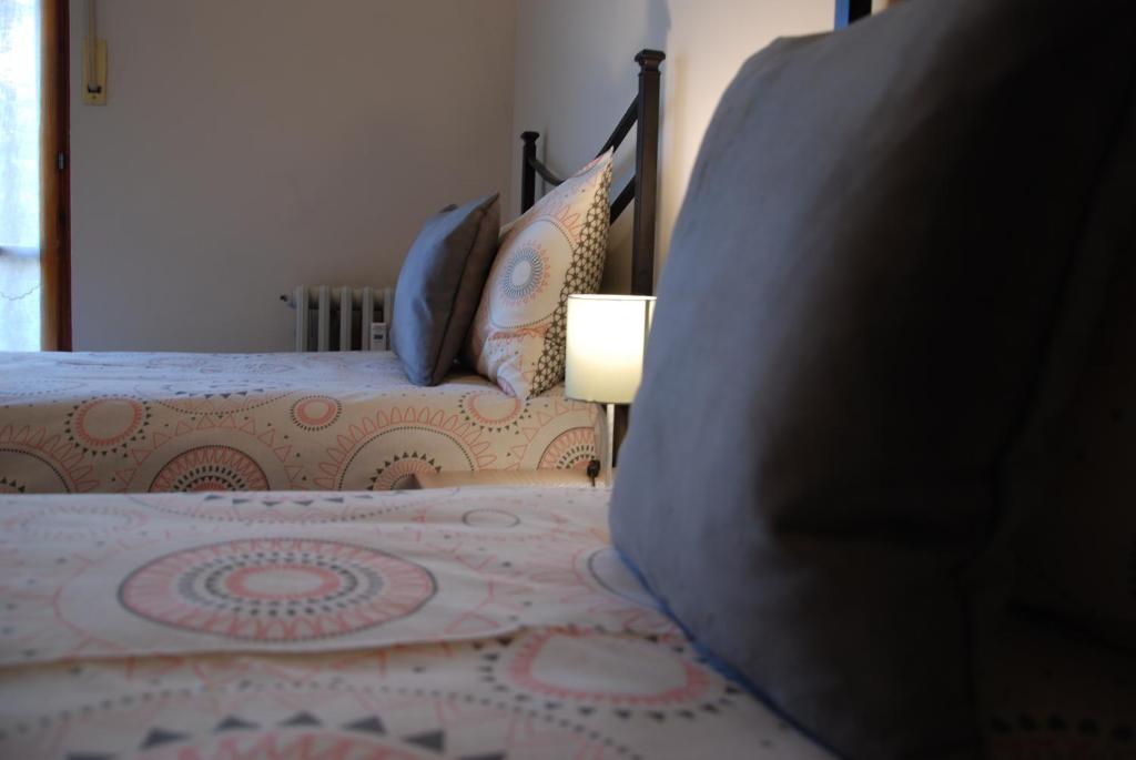 Un dormitorio con una cama con una lámpara al lado en Il Ponte, en Saint Vincent