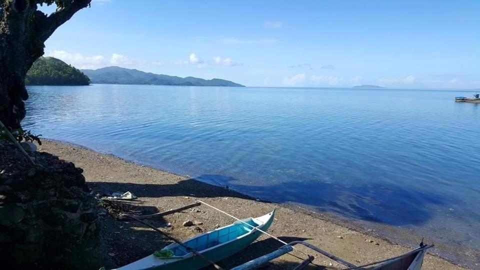 a boat on the shore of a body of water at Leyte Seaview Stay in Himay-añgan