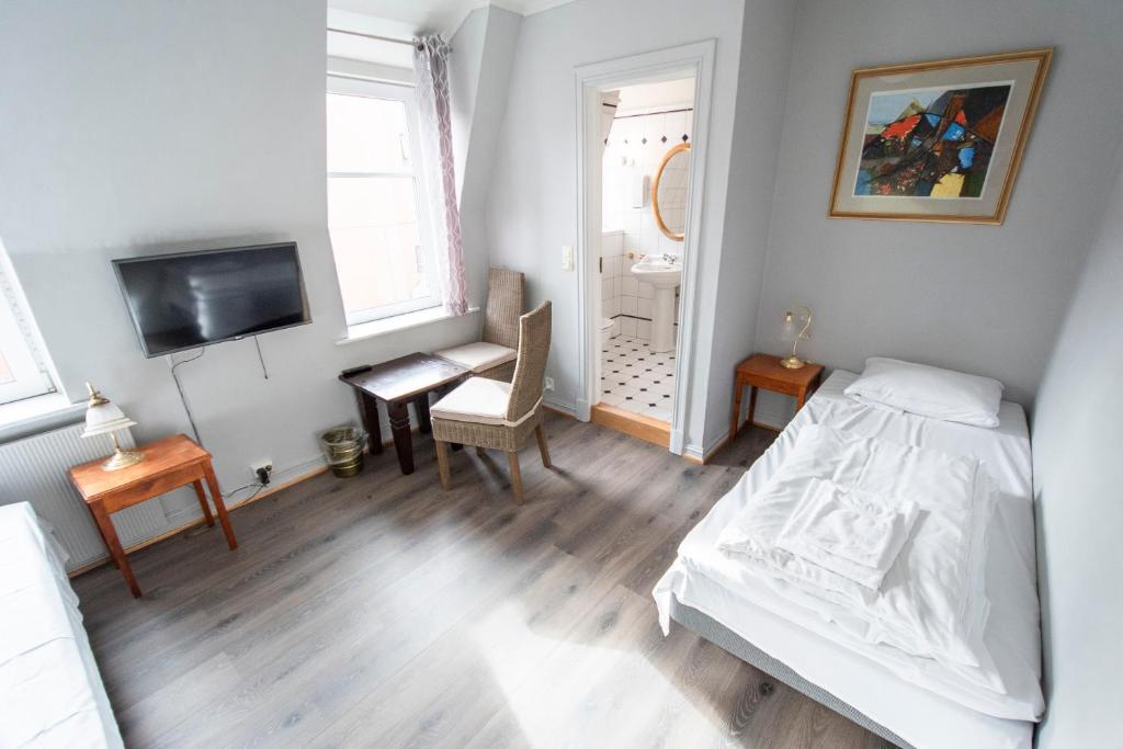 Postel nebo postele na pokoji v ubytování Grand Hotel Hønefoss