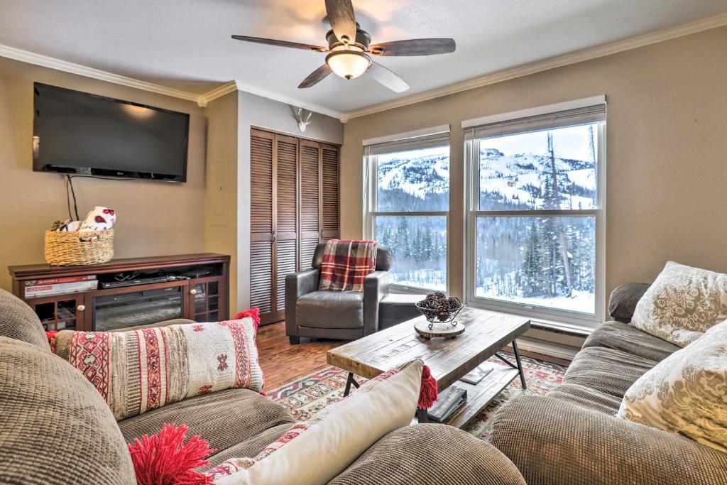 a living room with a couch and a tv at Copper Chase Condo Less Than 1 Mile to Brian Head Skiing! in Brian Head