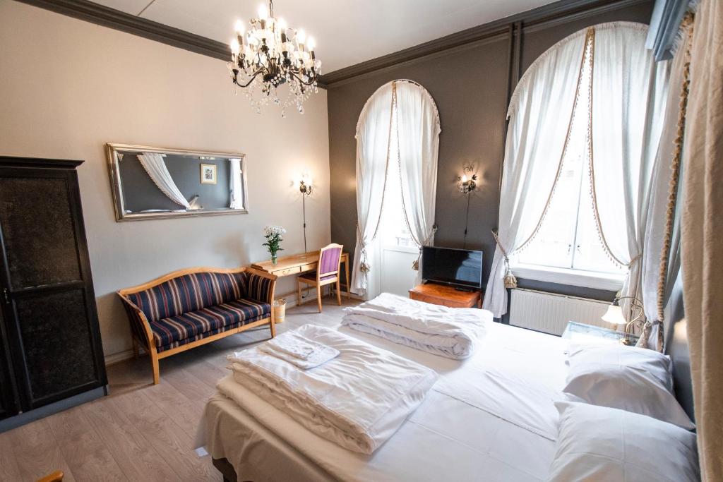 Postel nebo postele na pokoji v ubytování Grand Hotel Hønefoss