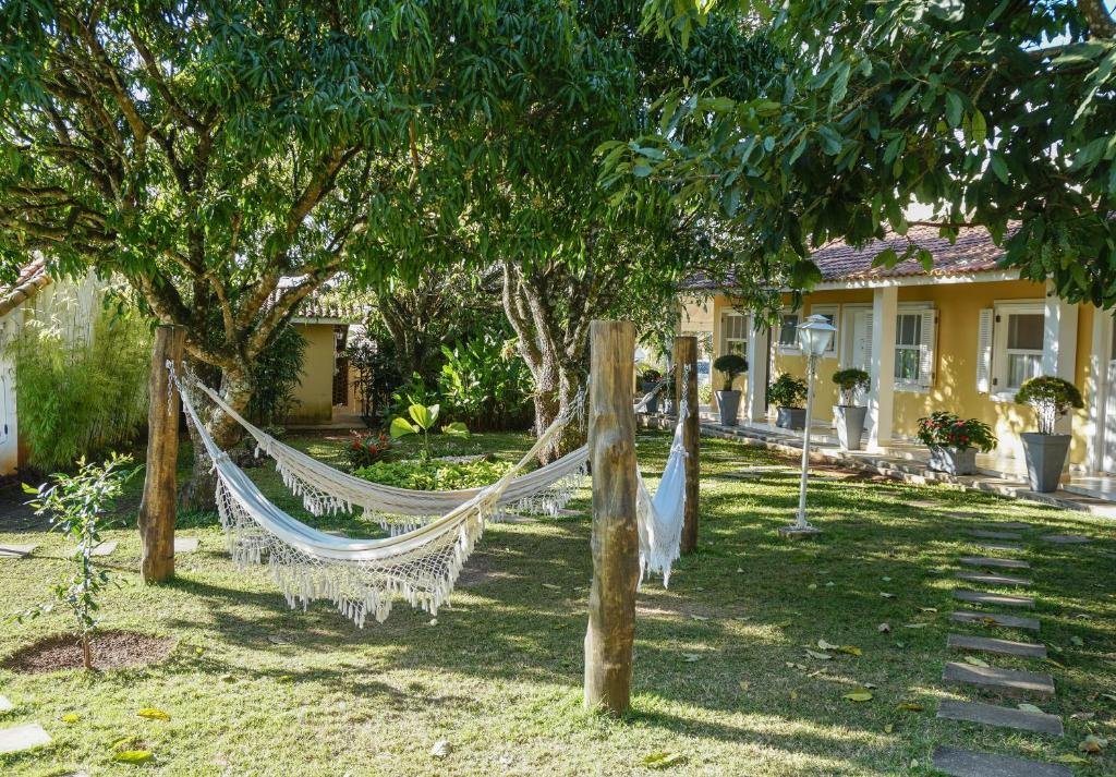 a hammock in a yard in front of a house at Alambari Village in Alambari