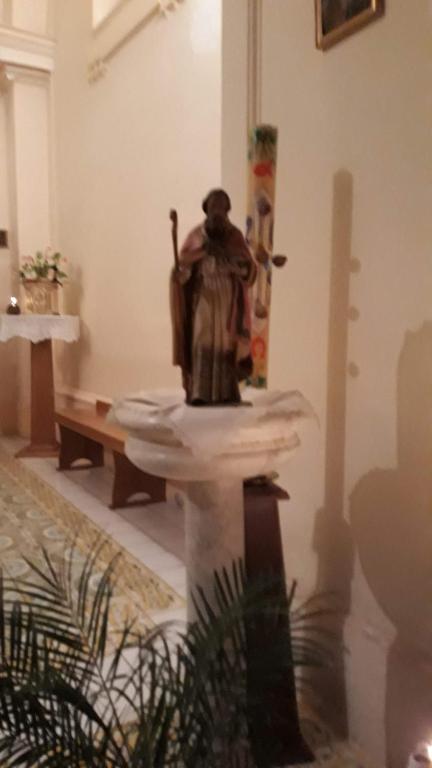 a statue of a man sitting on a table in a room at Emidio House in Termini