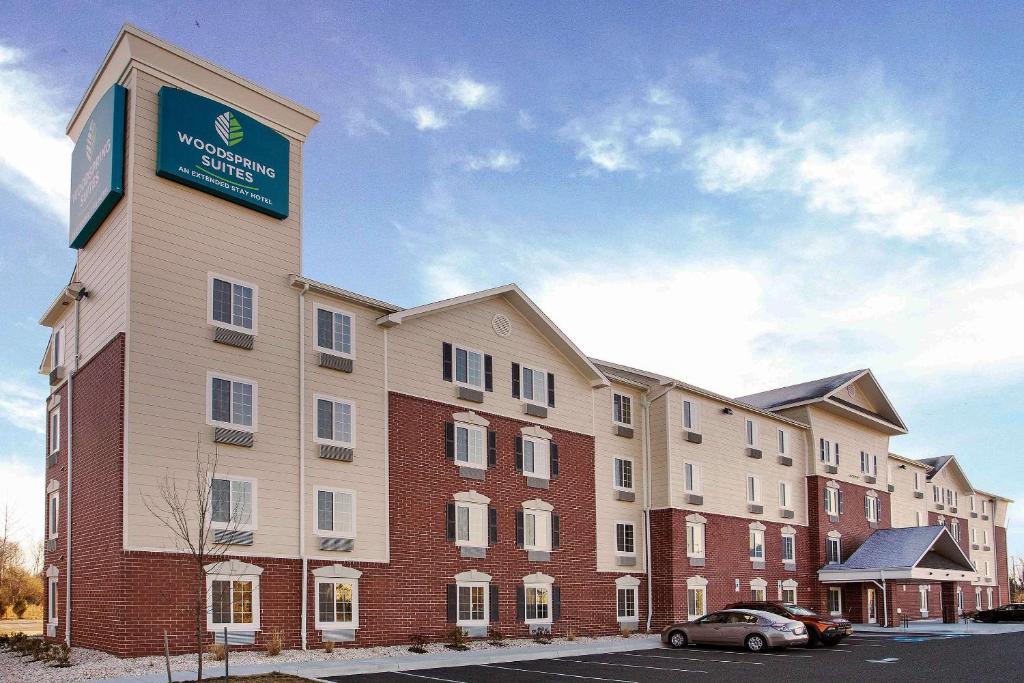 a large building with a sign on the side of it at WoodSpring Suites Frederick I-70 in Frederick