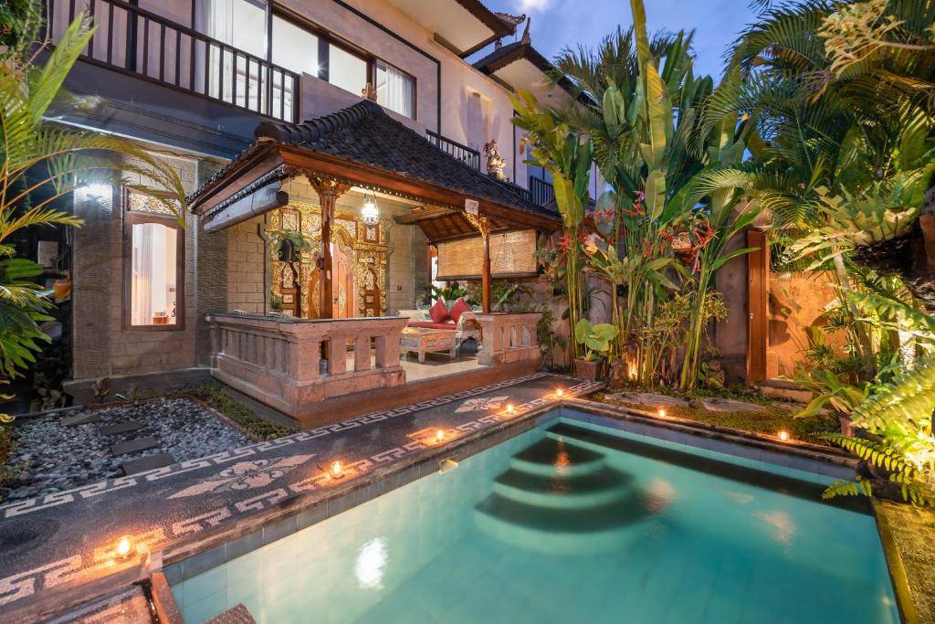 an indoor pool in a house with a villa at Ashanti Villa Ubud in Ubud