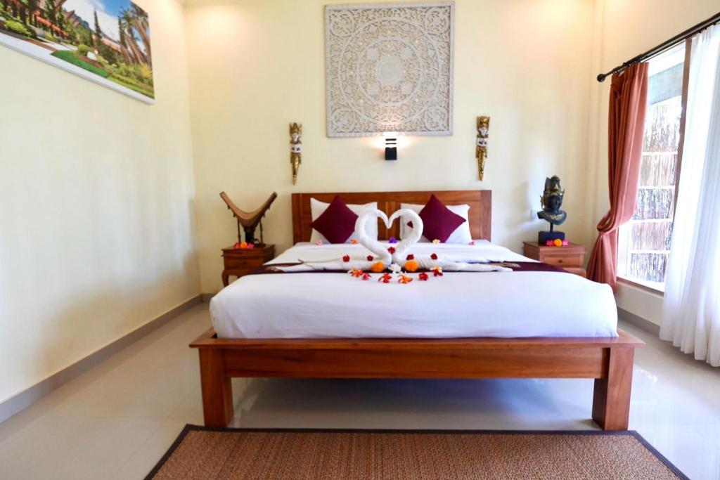 Postel nebo postele na pokoji v ubytování Vinayaka Ubud